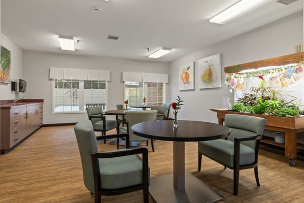 Bright common area with tables and plants