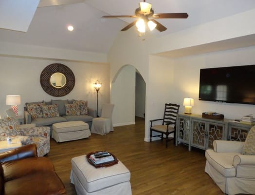 A spacious living room featuring comfortable seating and a television.