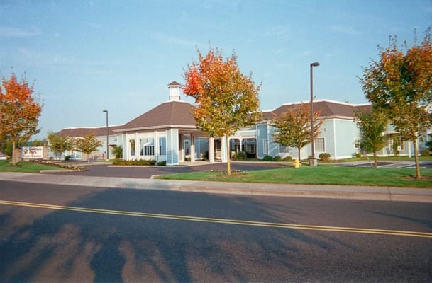 Exterior view of a senior living facility with landscaped trees