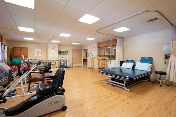 Rehabilitation exercise area with equipment and therapy space