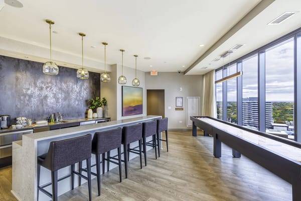Interior lounge area with bar seating and large windows