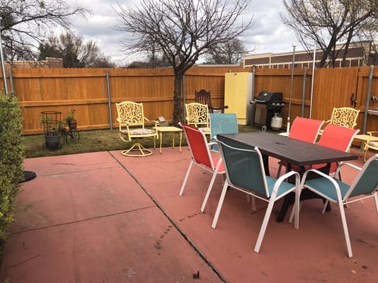 Outdoor seating area with colorful chairs and tables