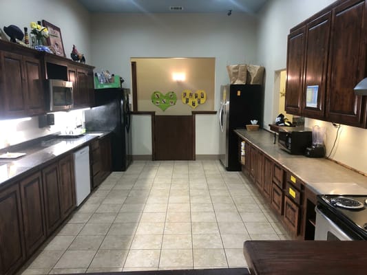 Interior kitchen space with wooden cabinets and appliances
