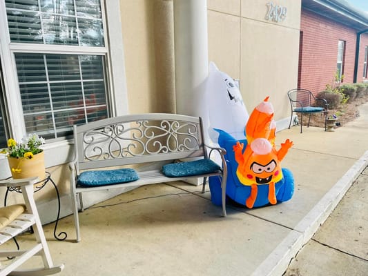 Bright inflatable characters next to a bench outside AvonLea Assisted Living
