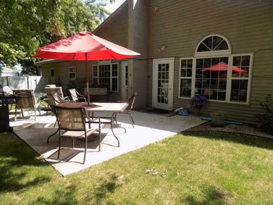 Patio area with seating and red umbrellas