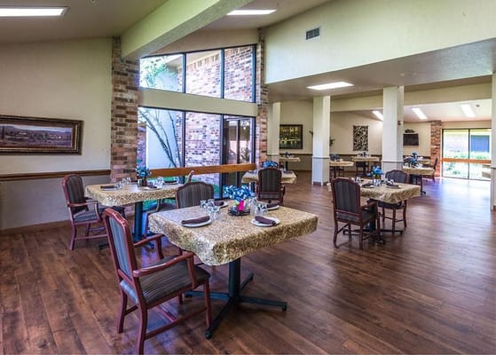 A dining room setup with tables and chairs