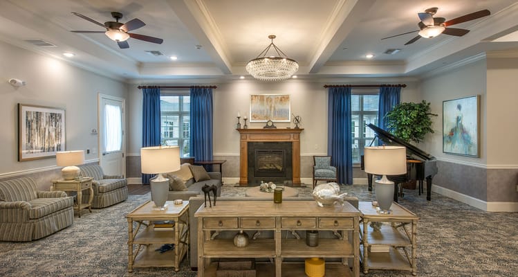 A cozy common area with seating and piano