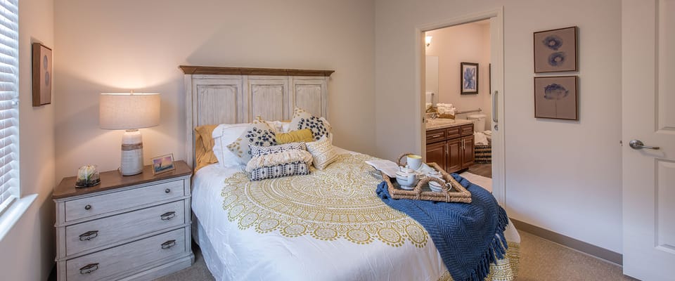 Well-decorated resident room with bed and furnishings