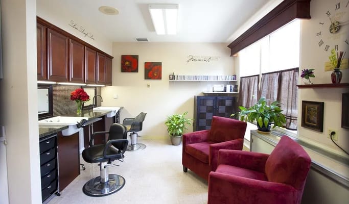 Salon area with red chairs and plants