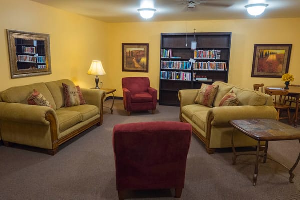 Interior common area with seating and bookshelves