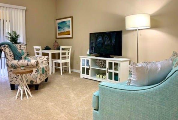 Bright and inviting living room with comfortable seating and a TV