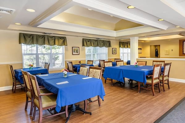 Bright dining room with blue tablecloths and flowers