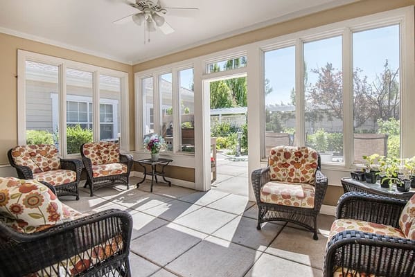 Bright sunroom with comfortable seating and plants