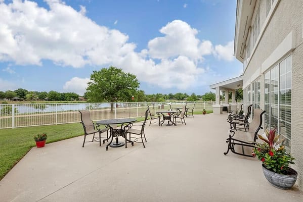 Outdoor patio with seating overlooking a lake
