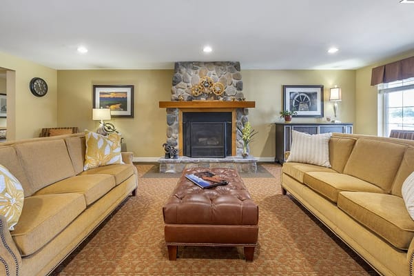 Cozy common area with stone fireplace and seating