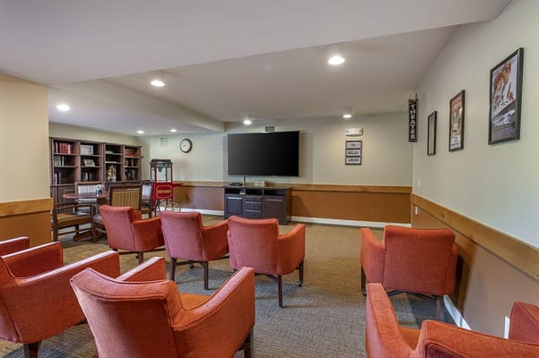 Bright common area with seating and a TV.
