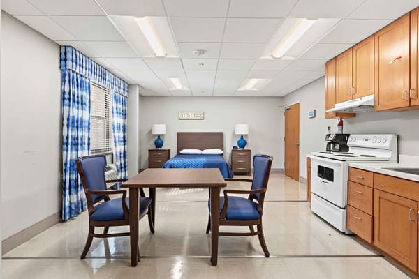 Cozy resident room with a bed and table