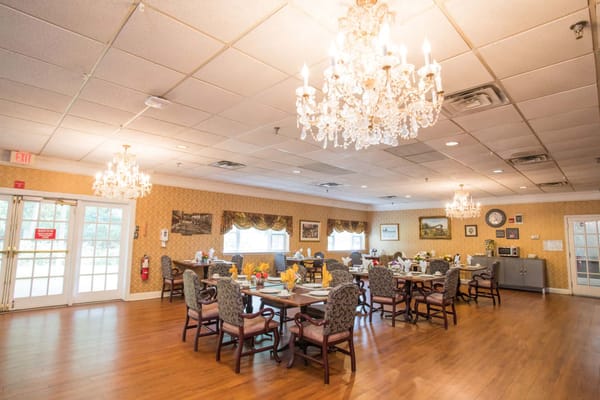 Dining room with elegant chandeliers and decorated tables