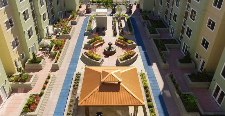 Aerial view of a landscaped courtyard with benches and a gazebo.