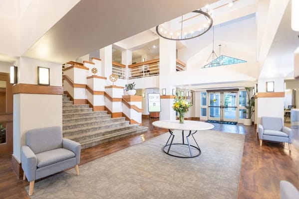 Bright and spacious lobby with seating and staircase