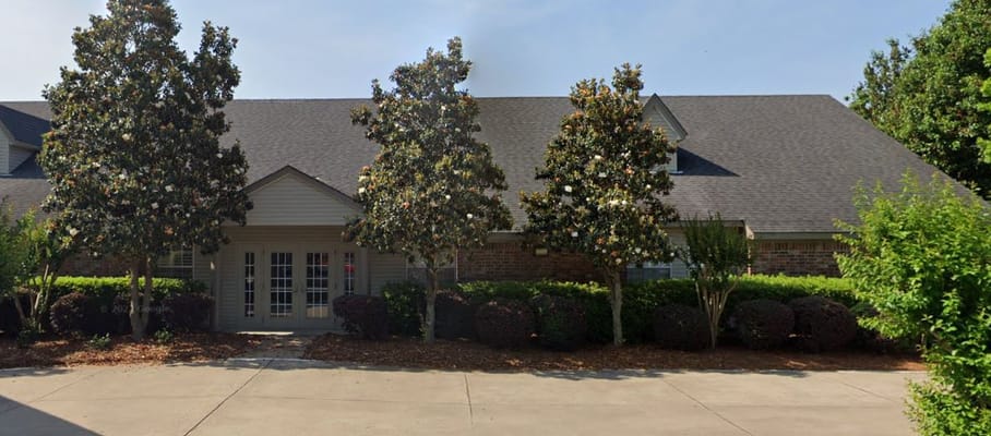 Exterior view of Colonial Oaks Rehabilitation Center with landscaping
