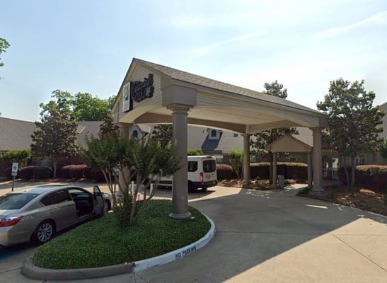 Entrance of Colonial Oaks Rehabilitation Center with vehicle