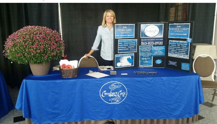 Staff member at a table showcasing home care services
