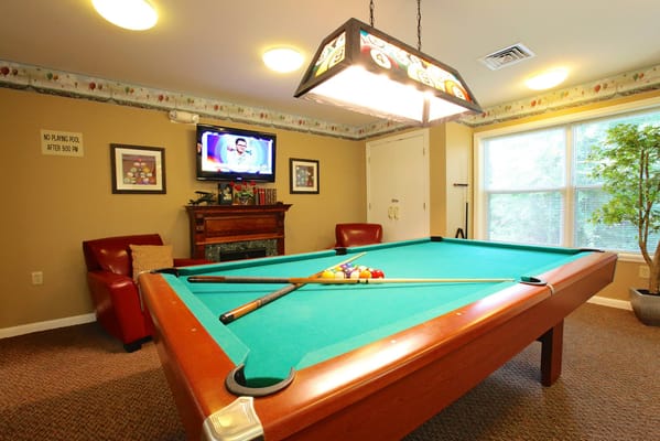 A billiard room in the common area of the facility