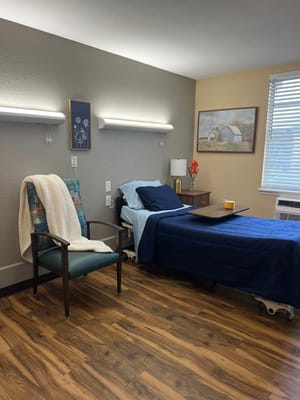 Cozy resident room with bed and chair