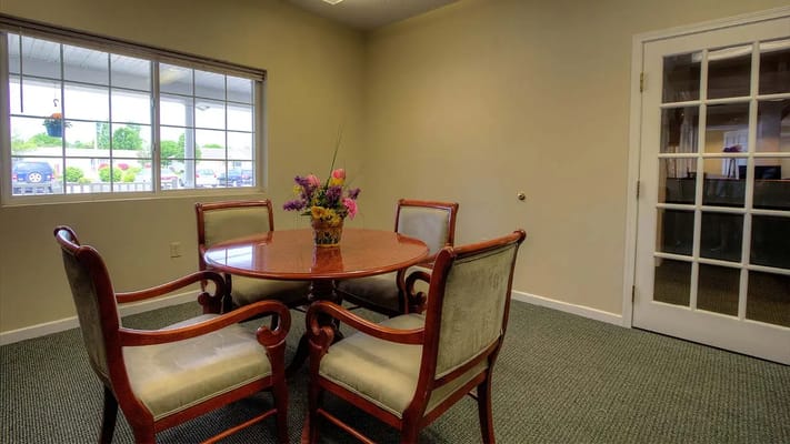 Quiet common area with a round dining table and flowers