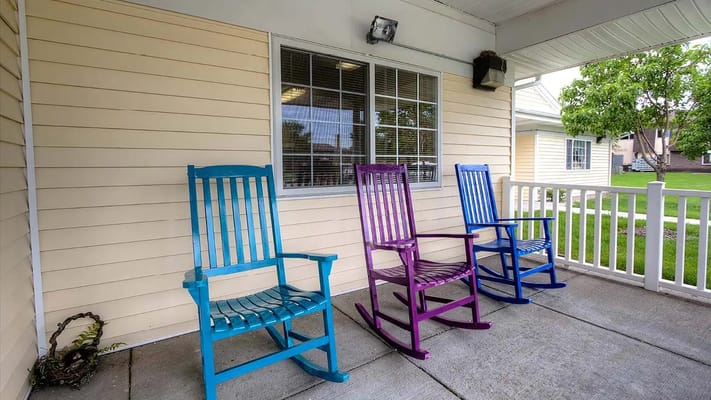 Colorful rocking chairs on a porch