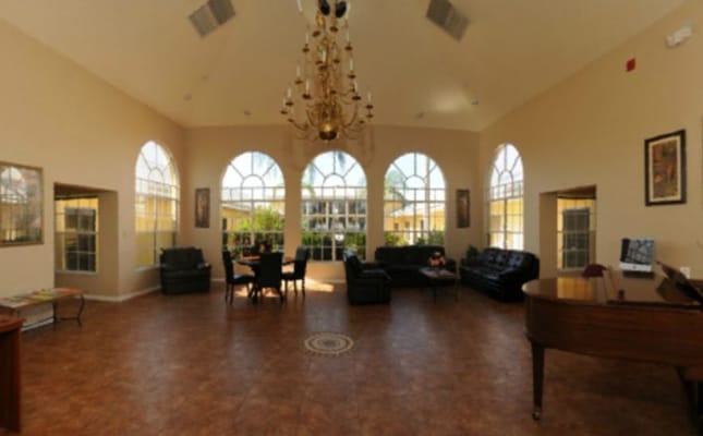 Bright lounge area with seating and piano.