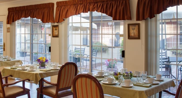 Bright dining room with tables set for a meal