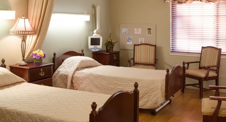 Shared resident room with two beds and seating area