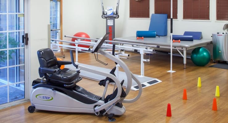 Rehabilitation equipment in a bright therapy room