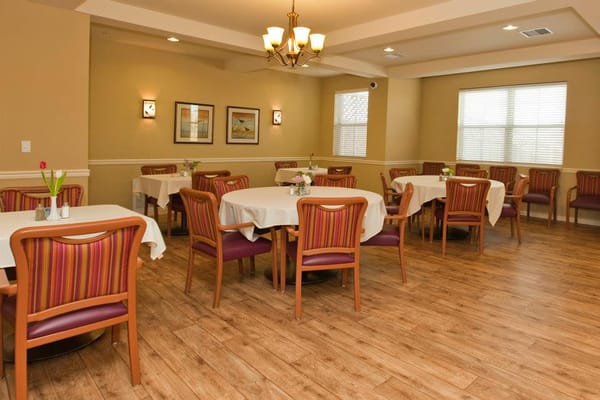 Bright dining room with tables and chairs set for meals