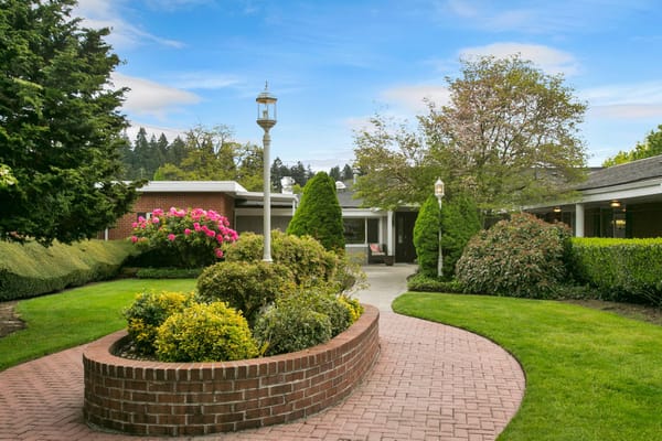 Scenic garden path with shrubs and flowers at Discovery Nursing & Rehab.