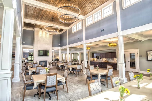 Bright dining room with tables set for residents