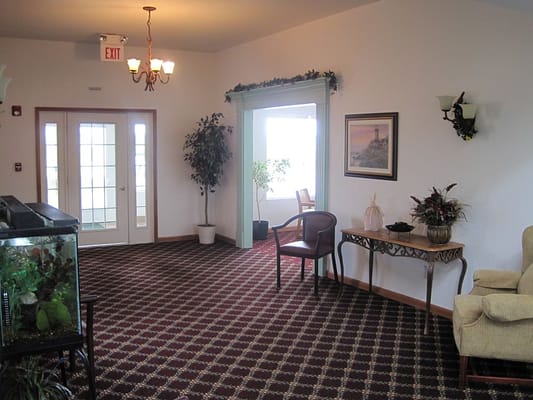 Inviting lobby area with plants and comfortable seating.