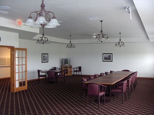Common area with a large table and chairs in Eagle Springs facility.