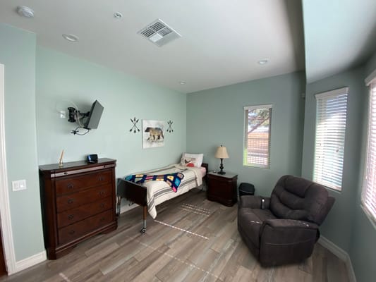 Comfortable resident room with a bed and armchair