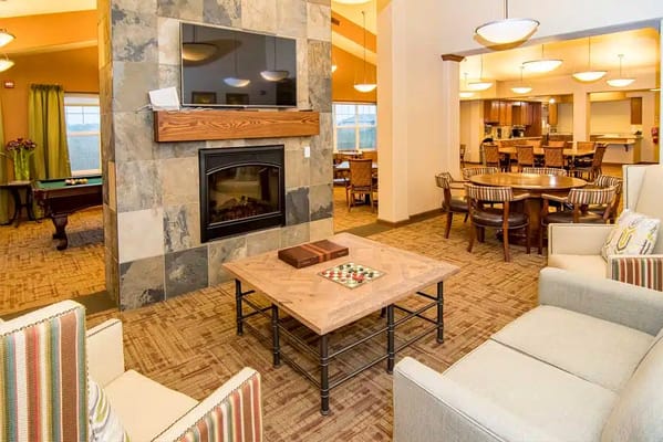 Inviting common area with fireplace and seating at Edgewood Pierre