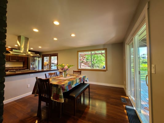 Bright dining area with a table and flowers