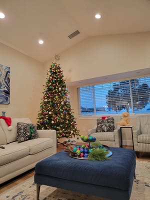 Cozy common area with a festive Christmas tree