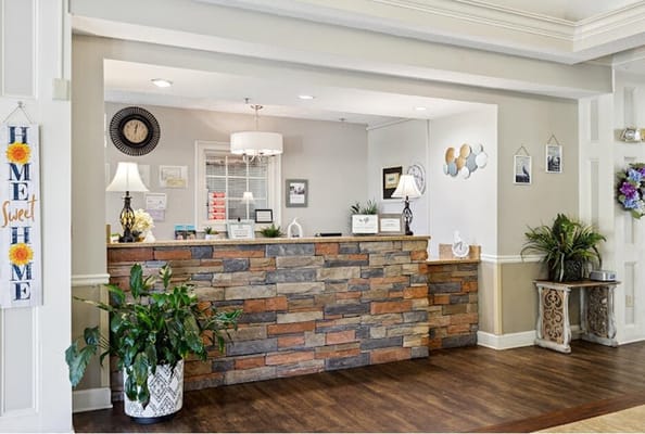 Welcoming reception area with a stone front desk