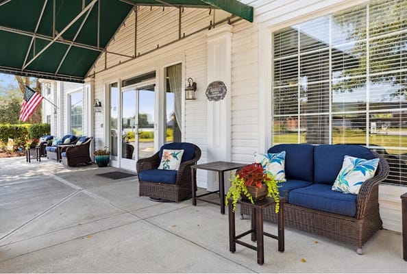 Outdoor seating area with plants and flag