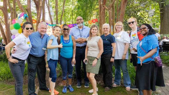 Group of residents and staff celebrating outdoors