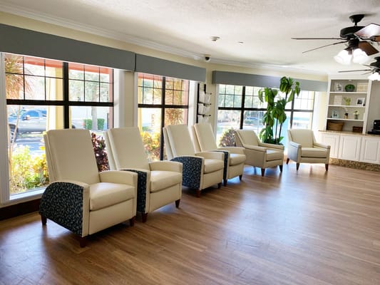 Comfortable lounge chairs in a bright area with large windows