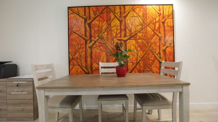Cozy dining area with a wooden table and art on the wall