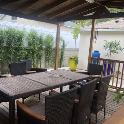 Outdoor dining area with wooden table and chairs